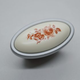   Fém-műanyag bútorgomb, matt króm színű, virág mintával