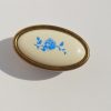 Fém-műanyag bútorgomb, bronz színű kék virág mintával