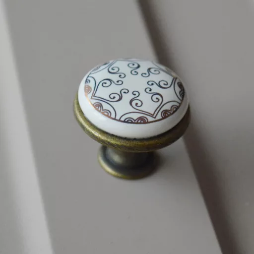 Fém-porcelán bútorgomb, bronz talp - arany színű motívummal 