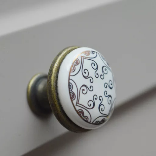 Fém-porcelán bútorgomb, bronz talp - arany színű motívummal 