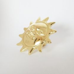 Metal furniture knob with golden sun motif