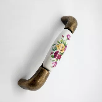   Porcelán-fém bútorfogantyú, bronz színű fém végek/tört fehér porcelán, virág mintával, 96 mm furattávval