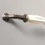 Fém-porcelán bútorfoganytú, krém - bronz színű, 128 mm furattávval